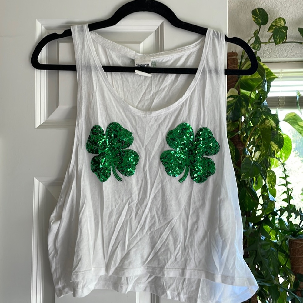 White crop tank,  green shamrock sequins, wide opening in arm pit. Light use